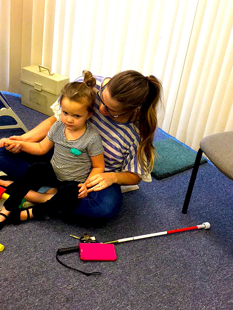 A mother helping her child to learn at make it take it.